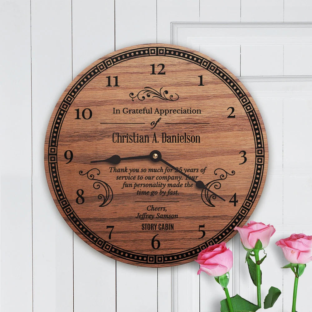 Wooden wall clock with engraved text on a white wooden background with pink roses.